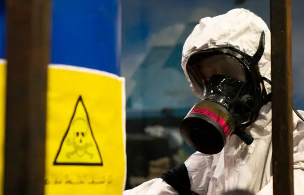 People in protective suits in the laboratory for the production of chemical and biological weapons. The threat of the use of weapons of mass destruction by Arab States.