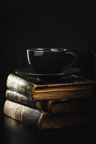 istock Coffee mug and antique books. 1322352792