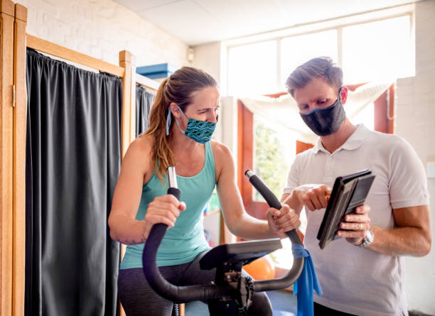 istock Trainer showing training progress on digital tablet to woman 1322354480