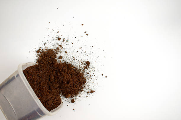 istock Ground in a plastic box on a white background. Ground is is scattered. Isolate. Plant transplant concept. Copy space. Flat lay. 1322356028