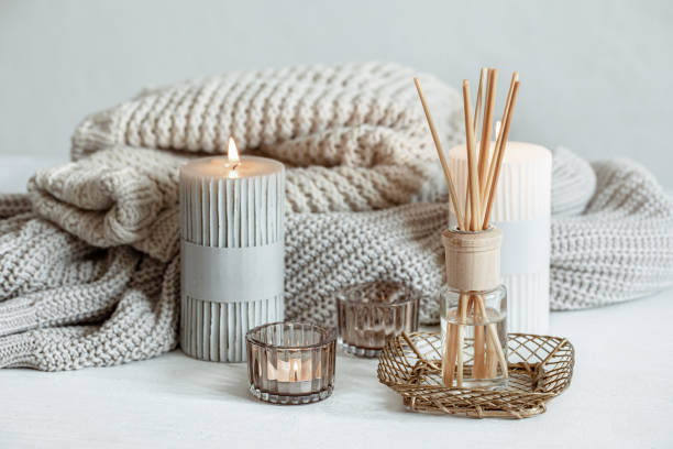 istock Cozy home composition with candles, aroma sticks and a knitted element. 1322358973
