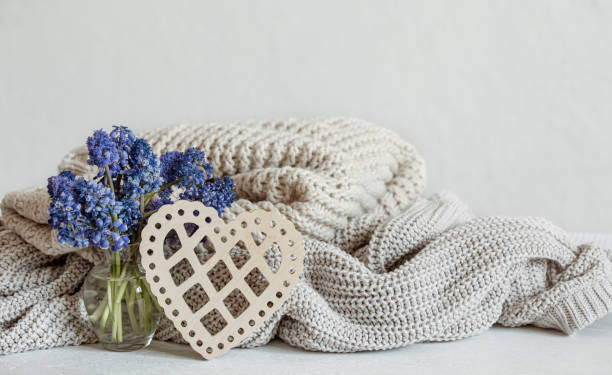 istock Cozy composition with flowers, knitted items and a decorative heart. 1322358987