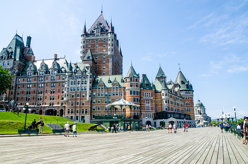 Dufferin boardwalk with people, cannon and Château Frontenac during nice day of springtime in Old Quebec