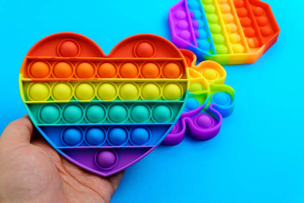 istock Colorful antistress touch pop it toy. On a blue background. 1322360932