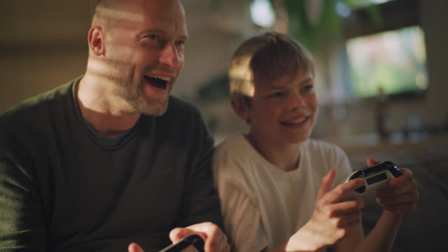 Screen time during pandemic. Father and sons playing video games