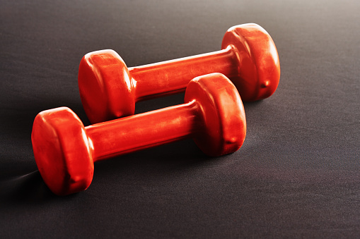 Red dumbbells with copy space.