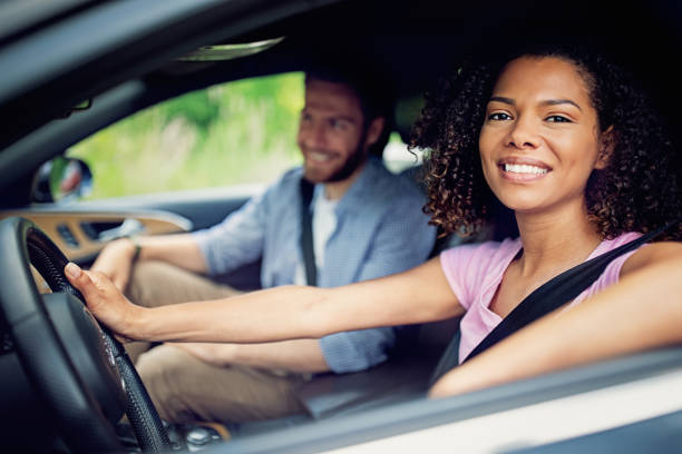istock Couple driving a car and having fun 1322362180