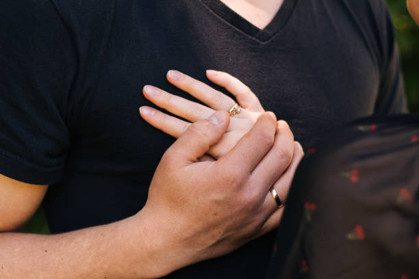istock loving couple holding hands close up on blurred background 1322362751