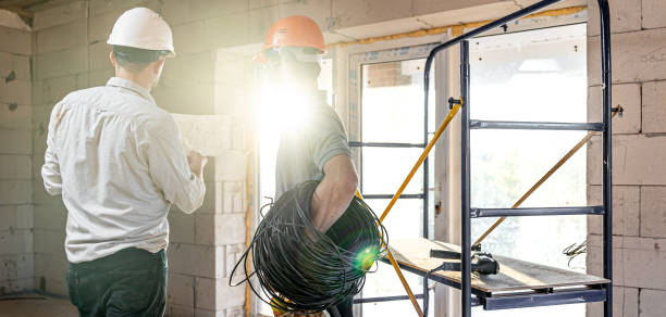 istock Two builders look at the drawing of the object 1322363544
