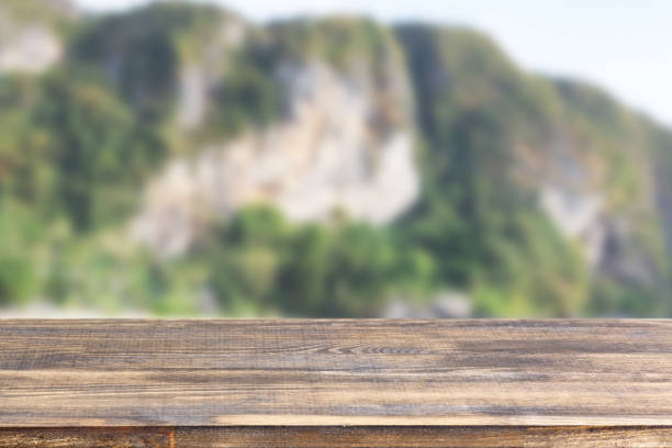 istock wood table top on blurry mountains background 1322363575