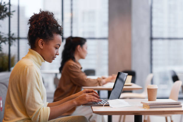 istock Young Woman Working in Cafe Side View 1322365318