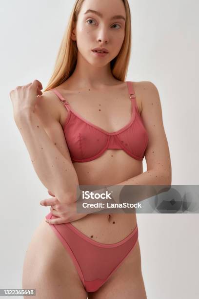 Beautiful Young Caucasian Female Model With Slim Body Wearing Pink Transparent  Underwear Looking At Camera While Standing Isolated Over Light Gray  Background Stock Photo - Download Image Now - iStock