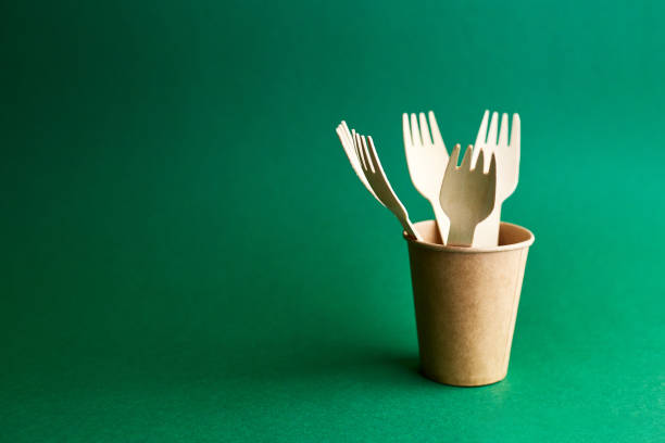 istock Eco friendly disposable dishes on green background. Sustainable lifestyle concept. zero waste, plastic free, stop plastic pollution. 1322367238