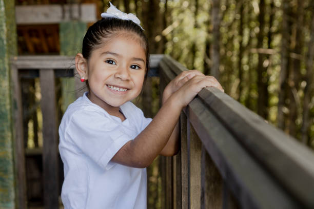 自然公園で少し幸せなヒスパニックの女の子、木の家で遊んで6歳の女の子 - グアテマラ 写真 ストックフォトと画像