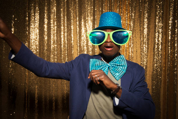 istock Young man wearing funny props and enjoying party 1322368726