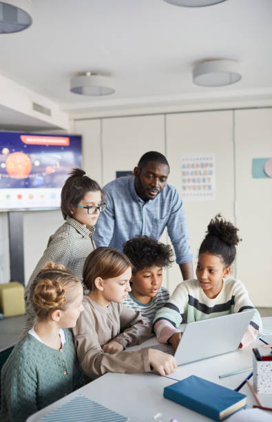 istock Group of Children Looking at Computer Screen in School 1322369782