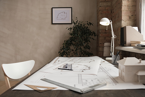 Empty minimalistic office with blueprints on table