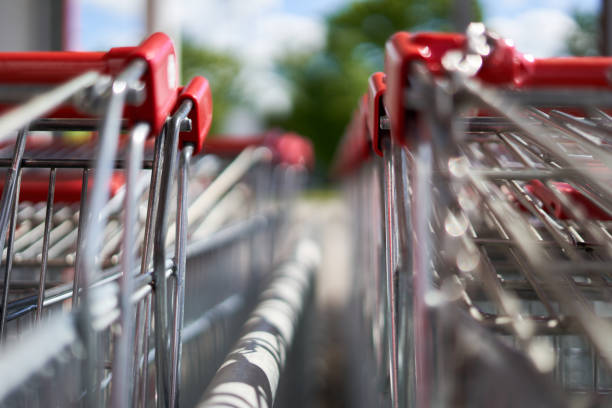 istock Red handles of shopping carts in 2 rows. View from the front. 1322371022