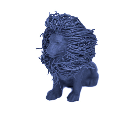 Objects printed by 3d printer Isolated on white background. Toy lion of blue color. Automatic three dimensional 3d printer performs plastic modeling in laboratory.