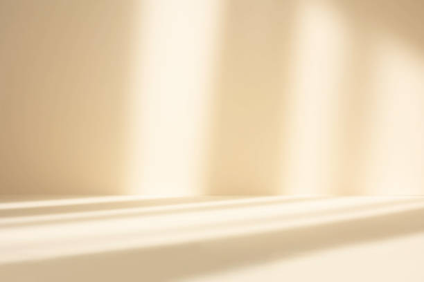 istock Abstract pastel yellow studio background for product presentation. Empty room with shadows of window. Display product with blurred backdrop. 1322376586