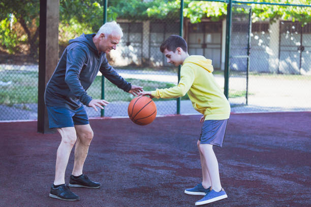 istock Happy grandfather and grandson practicing basketball 1322376998
