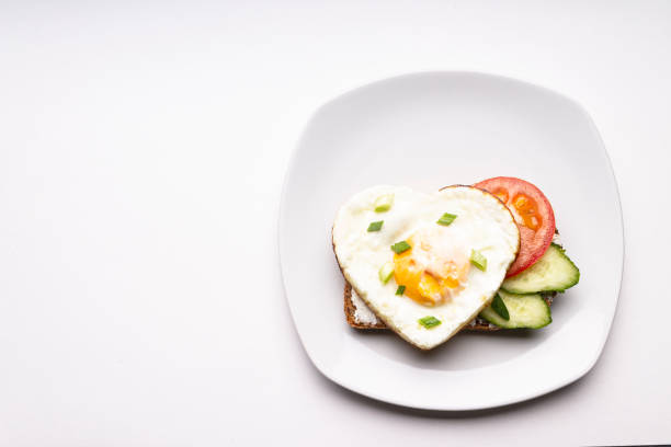 istock A sandwich with a heart-shaped egg on a white plate. 1322377050
