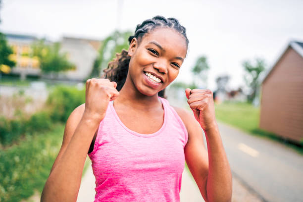 istock Woman runner in action outside in tree background 1322377053