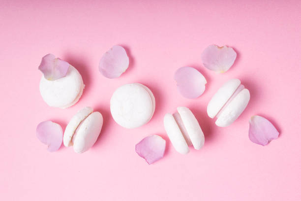 istock Macaroons and rose petals on a pink background. Horizontal orientation. 1322378272