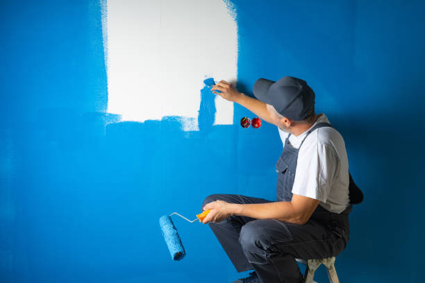 istock A lazy painter paints a wall sitting on a ladder. concept of tool selection. 1322380647