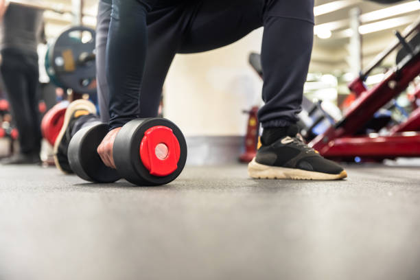 istock man holding dumbbell at gym 1322382225