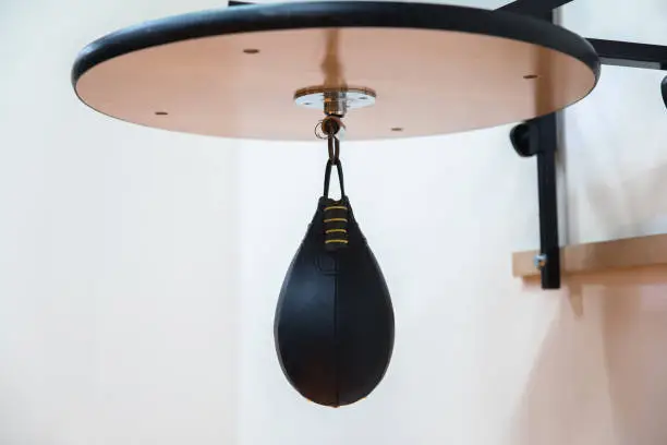Boxing speed bag with a fist on white background