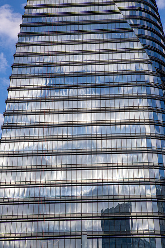 Sao Paulo, Brazil - May 26, 2021 - The glass facade of a modern architecture corporate office building located at Brigadeiro Faria Lima avenue on Vila Olimpia neighborhood.