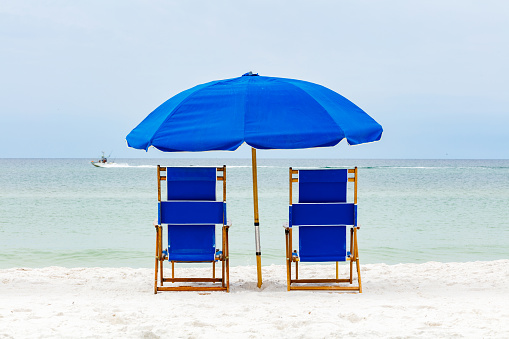 Beautiful North Florida panhandle beach with lounge chairs and umbrella.