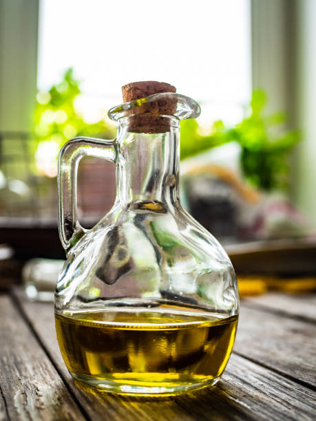 istock Olive oil in a bottle on wooden table 1322392753