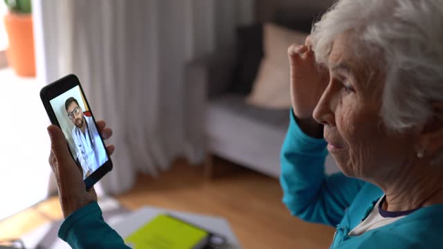 Senior woman on a telemedicine call with doctor at home