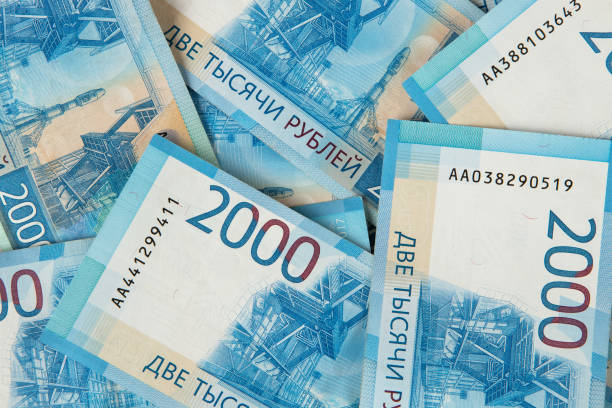 Background from Russian money, many banknotes rubles, denomination 2000, close-up. Concept of cash, salary, loan, wealth, sweet life, credit, finance, business, deposit, insurance. Top view, flat lay