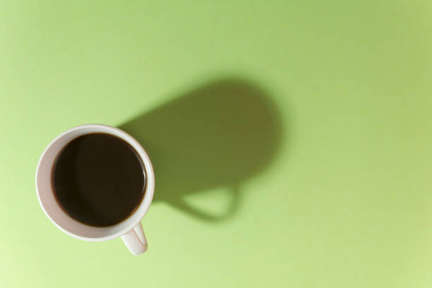 cup of coffee on a green background. view from above