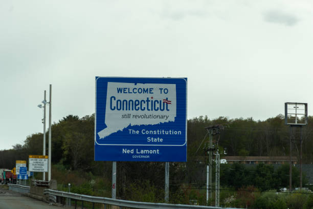 Welcome to Connecticut sign on a gray cloudy day with road construction signs stock photo
