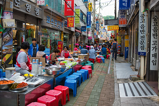 Busan, Korea - July 7th 2018, People having lunch on the aisle at the Gwangbok-dong Food Street, Busan Korea. 부산 광복동 먹자 골목