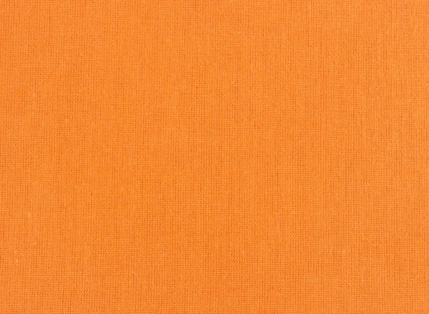 istock Closeup of orange textile. Fabric details backdrop 1322412021