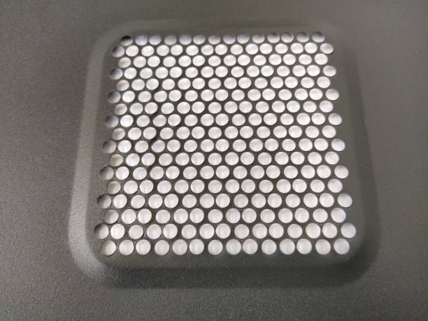 istock ventilation mesh of the computer. Metal surface with round numerous holes 1322414383