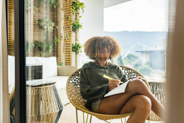 istock Woman taking notes on her porch 1322426541