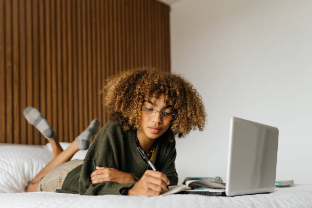 istock young woman studying in bed 1322426546