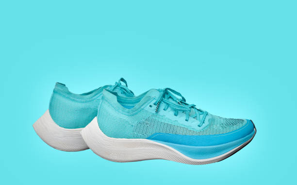 istock teal aqua running shoes isolated on blue background side view 1322429803