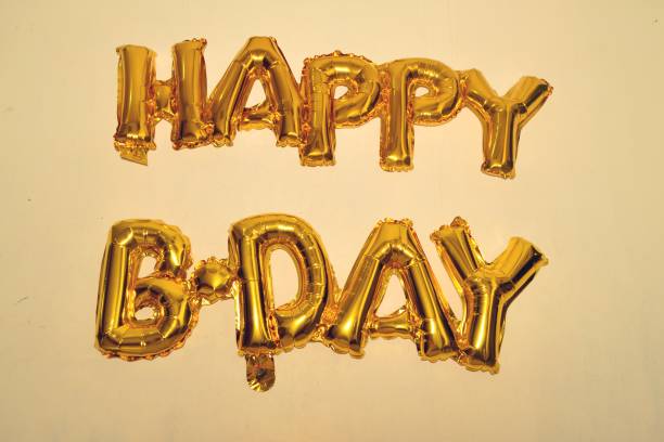 istock Gold Balloons happy birthday on the wall 1322430516