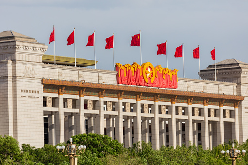 BEIJING - May 8, 2021: A portrait of Chairman Mao and armed police on the gate tower at Tiananmen Square. The celebration of the 100th anniversary of the founding of the Party will be held soon.