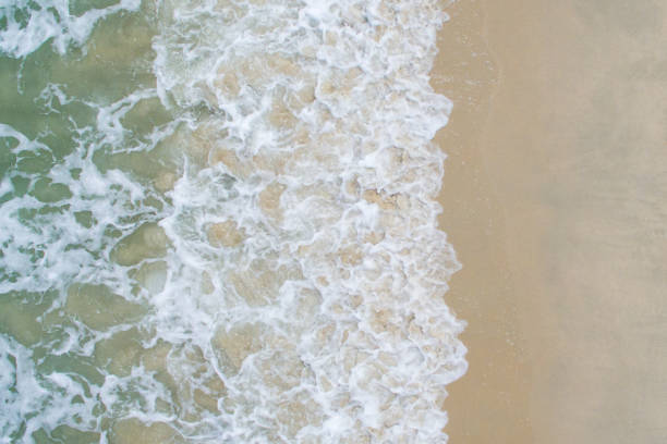 istock Soft wave of blue ocean on sandy beach. 1322431319