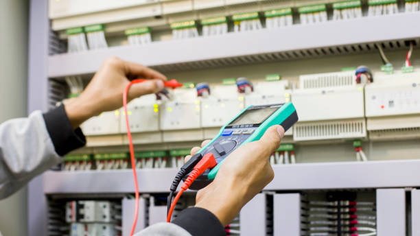 istock Electrical engineer tests the operation of the electric control cabinet on a regular basis for maintenance. 1322432288