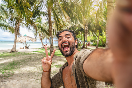 Young man taking selfie in a tropical island Colombia