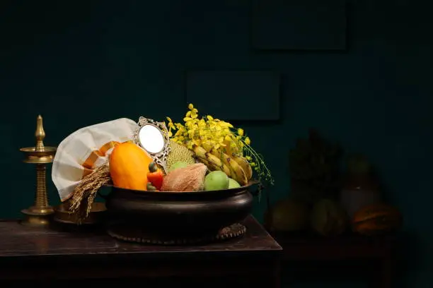Kerala festival,rituals of Vishu festival -Vishukkani or Vishu sight, a brass vessel  or Urule filled with fruits and vegetables mostly  available in this season.mirror,golden shower flower and new cloth or kassavu mundu arranged  traditionally on white background.